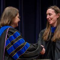 Christine shaking hands with awardee